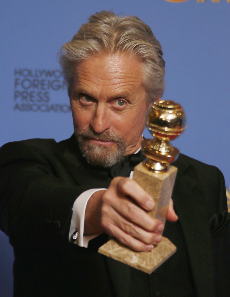Image: Michael Douglas poses backstage with the award for Best Actor in a Mini-Series or TV Movie for his role in \"Behind the Candelabra\" at the 71st annual Golden Globe Awards in Beverly Hills